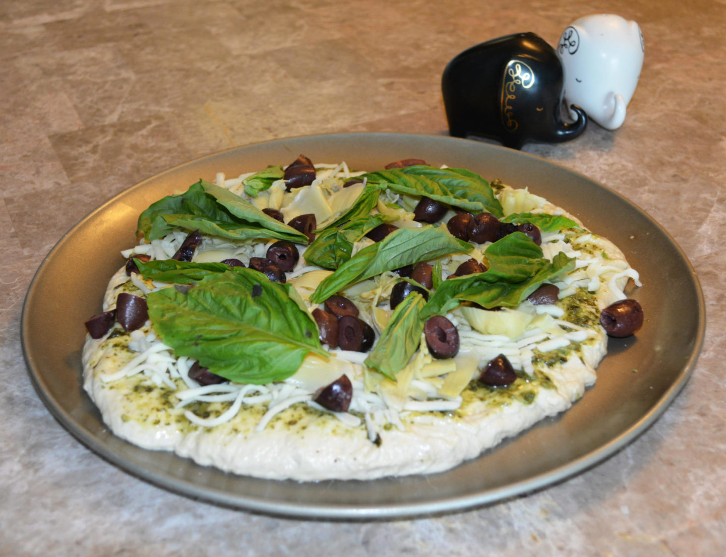 Pesto Pizza with Artichoke, Black Olives & Basil